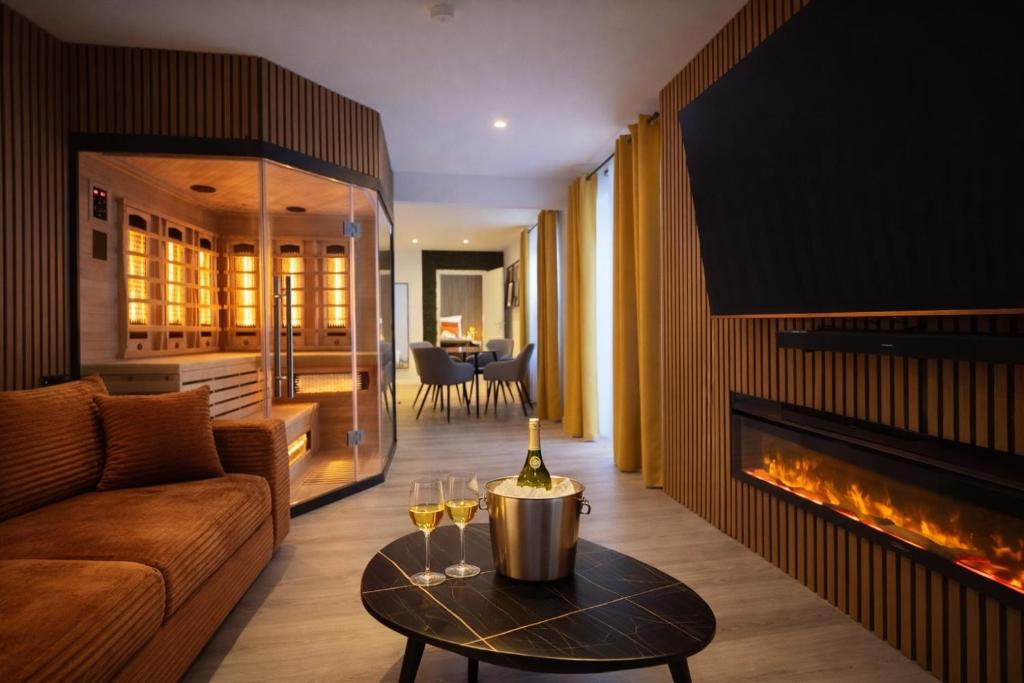 a living room with a couch and a fireplace at VonMos Moselblick Apartments in Kinheim