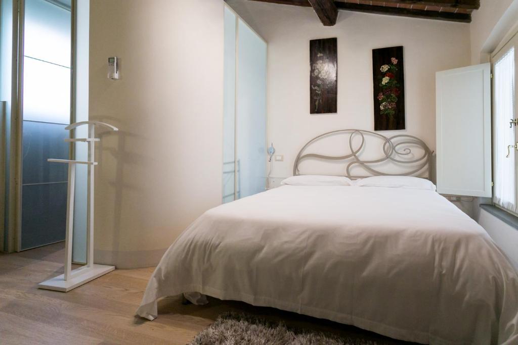 Łóżko lub łóżka w pokoju w obiekcie Relais Pacinotti Apartments