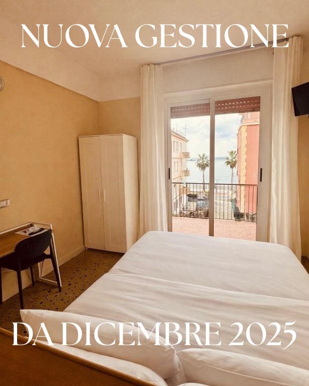 a bedroom with a bed and a door to a balcony at Hotel Elisabetta in Sestri Levante