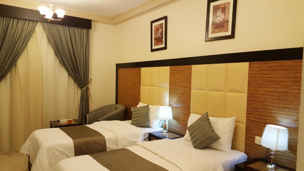 Postel nebo postele na pokoji v ubytování ديار المشاعر الهداية الفندقية Diyaralmashaer Al-Hadiyah Hotel