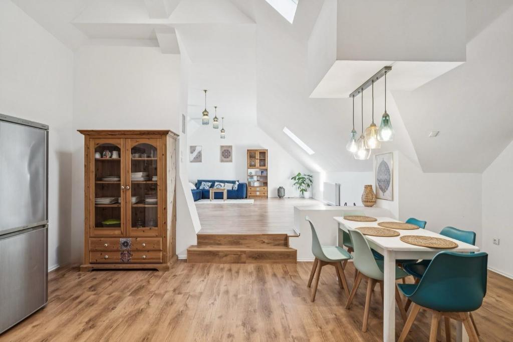 a kitchen and dining room with a table and chairs at Natururlaub Eifel-Mandala Feriewohnung in Kall