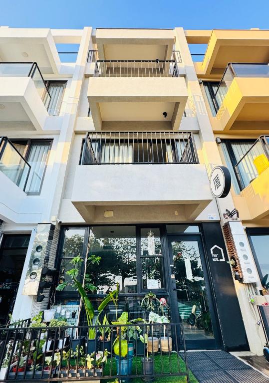 an apartment building with a balcony with plants at 厝True Hub旅店 in Nanwan