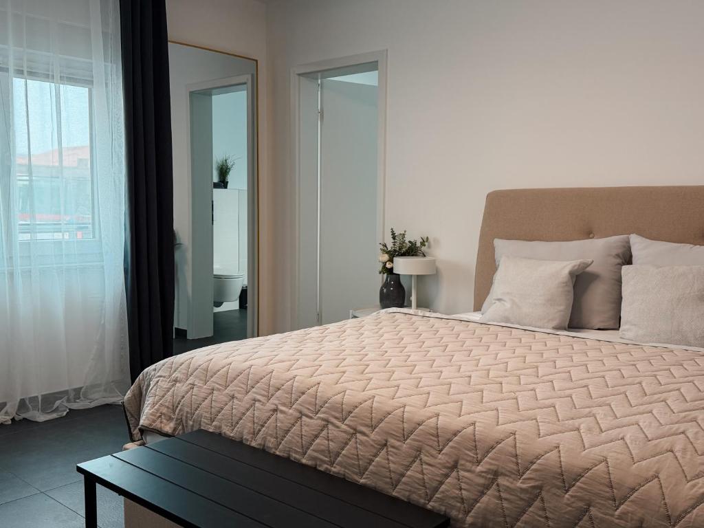 a bedroom with a large bed and a window at Comfort Apartment Midami in Schwanau