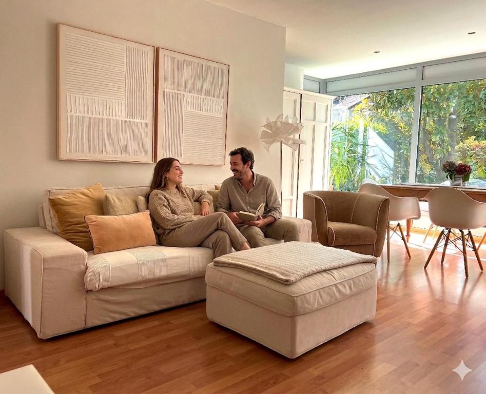 a man and woman sitting on a couch in a living room at Villa Maria in Rablà