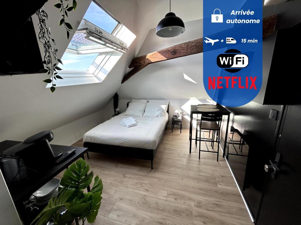 a bedroom with a bed and a desk in a room at Le Studio - Centre de Vertou, cosy et calme in Vertou