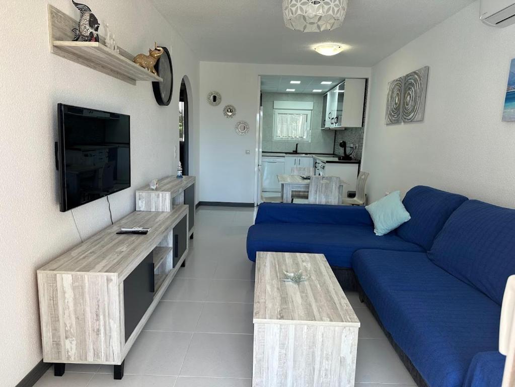 a living room with a blue couch and a table at APARTAMENTO HECO in Peniscola
