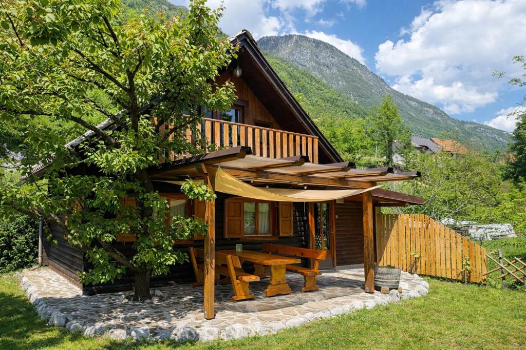 a log cabin with a picnic table in front of it at Edi Cottage in Bovec