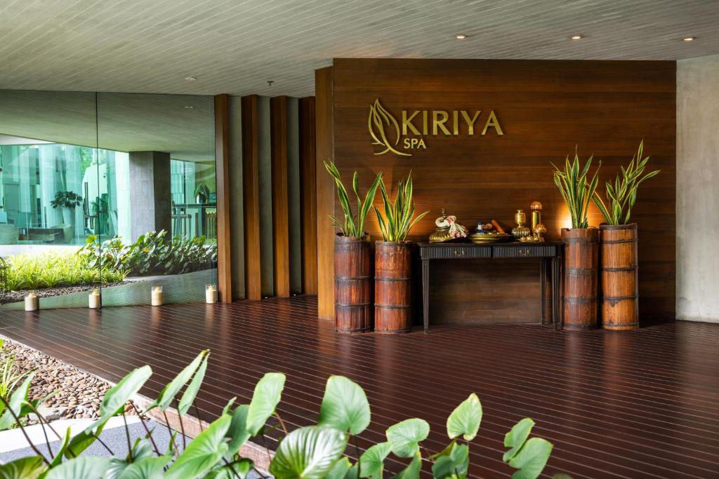 A spa-branded lobby entrance with a plant-filled reception display.