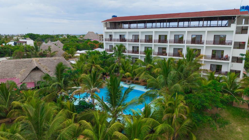 an aerial view of a hotel with palm trees at Malika Nungwi Hotel in Nungwi