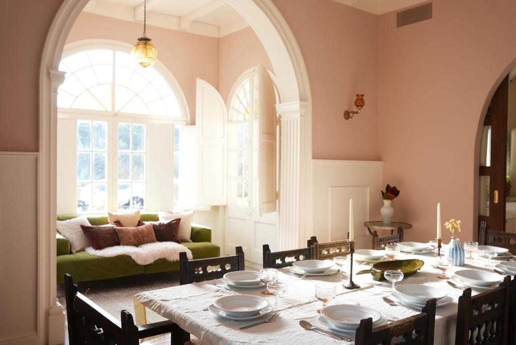 a dining room with a table and a couch at La Torre Retreat in Borredá