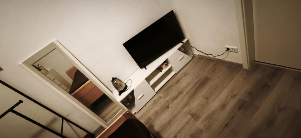 a living room with a flat screen tv on a wall at OneRoomStay in Delmenhorst