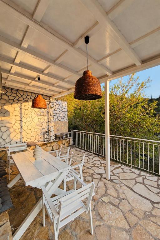 a patio with a table and chairs and two lights at Salt & Stone in Drymon