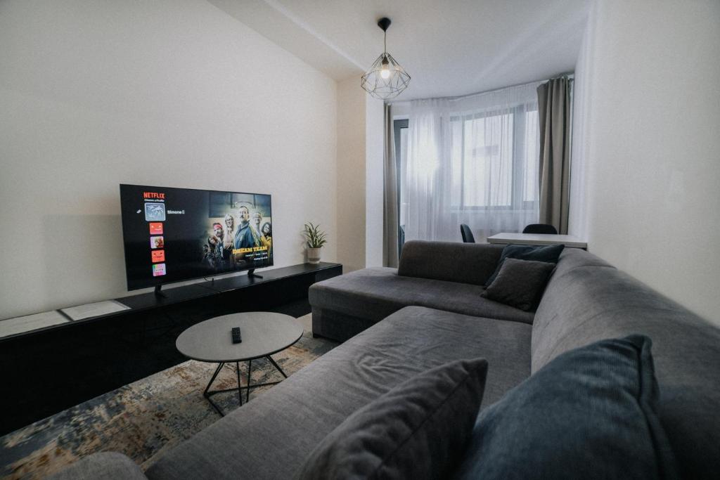 a living room with a couch and a tv at Apartmán Melissa in Žilina