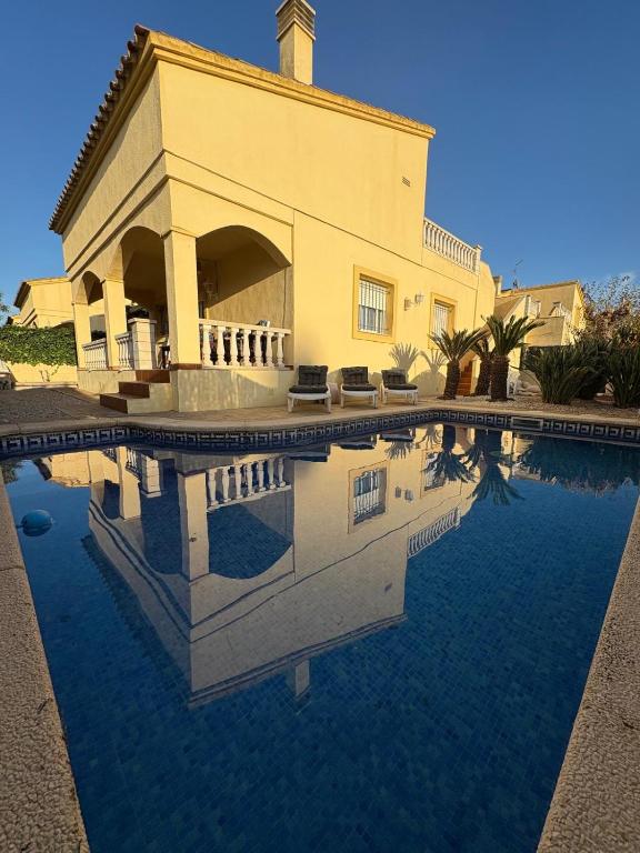 a large house with a pool in front of it at Casa Campanilla in Riumar