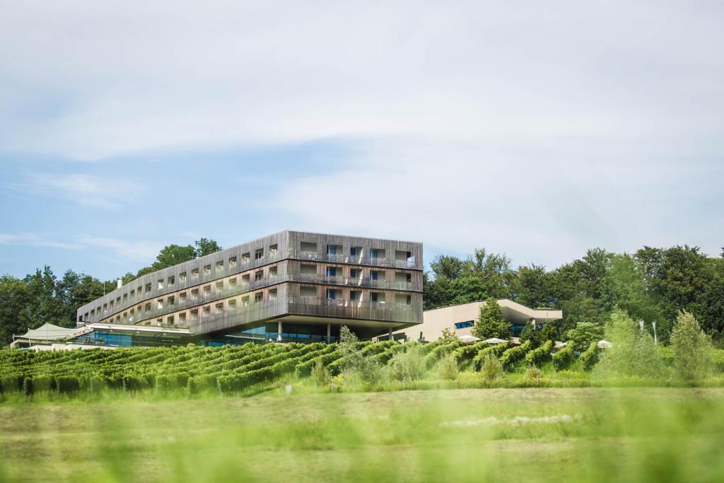 a building in the middle of a field at LOISIUM Wine & Spa Hotel Südsteiermark in Ehrenhausen
