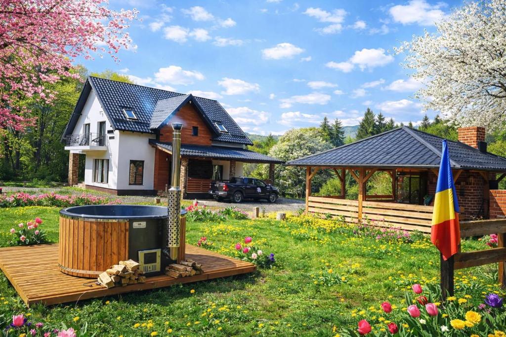a house with a hot tub in the yard at Poiana Cerbilor in Slatina