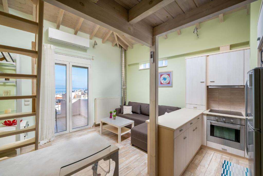 a kitchen and living room with a view of the ocean at Panorama City Loft in Mytilene