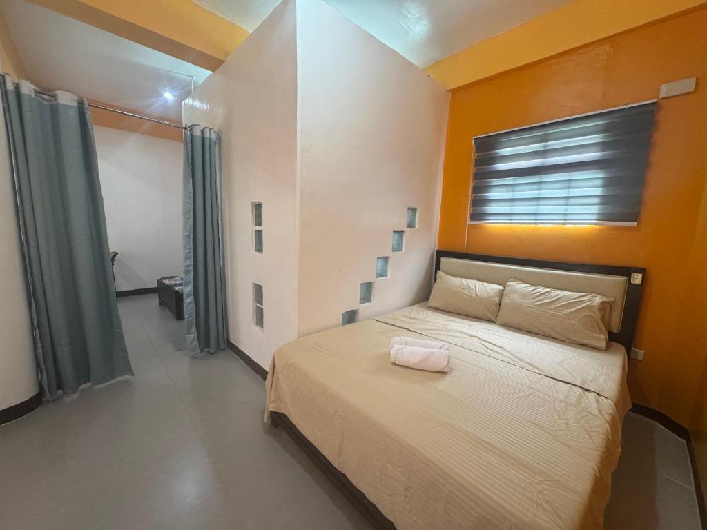 a bedroom with a large bed with a window and a bed at Boracay Garden Retreat in Boracay
