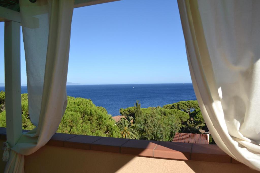 a window with a view of the ocean at Magic View in Tuscany in Capo D'Arco