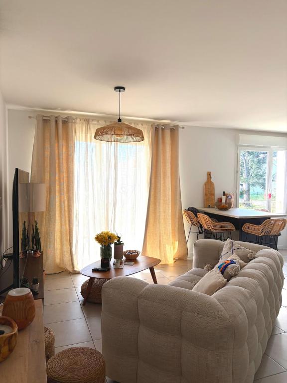 a living room with a couch and a table at Cozy Home in Roussillon en Isere