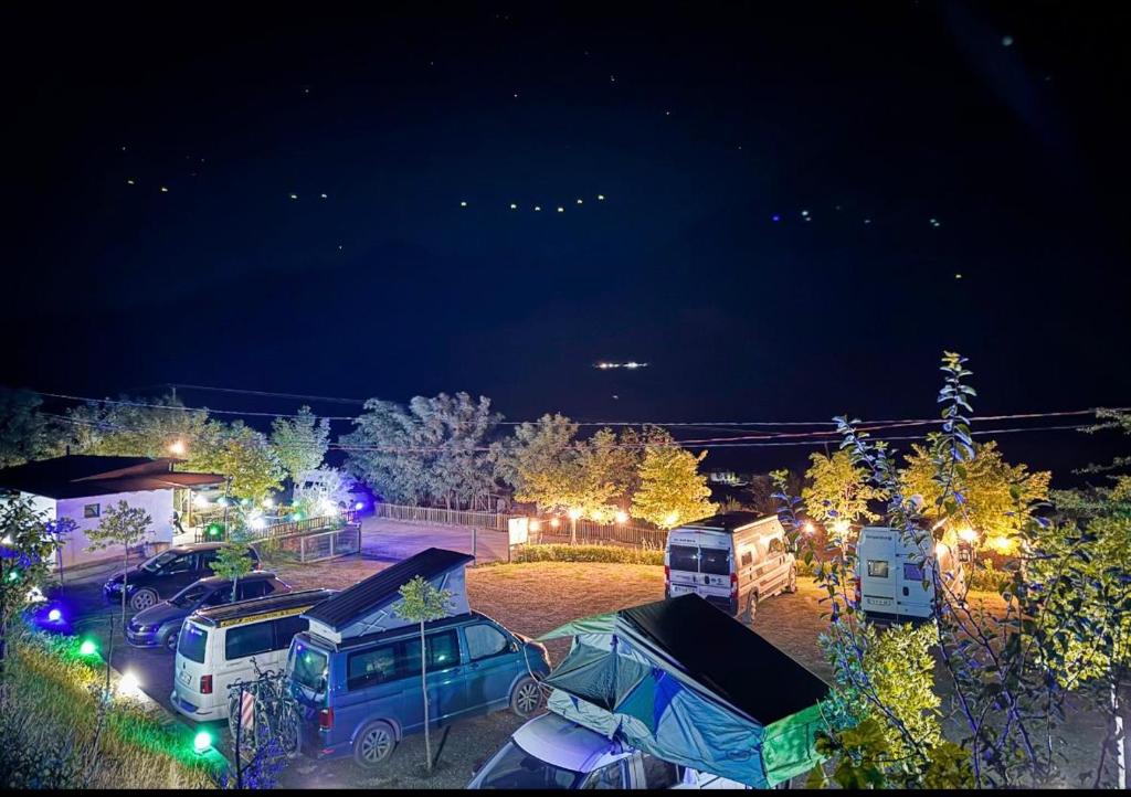 a group of vehicles parked in a parking lot at night at Camping Koman in Koman