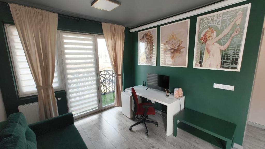 a room with a desk and a computer on a green wall at YoniHarmony - 2 parking places in Sosnowiec