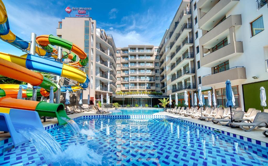a pool with a water slide in a resort at Best Western PLUS Premium Inn in Sunny Beach