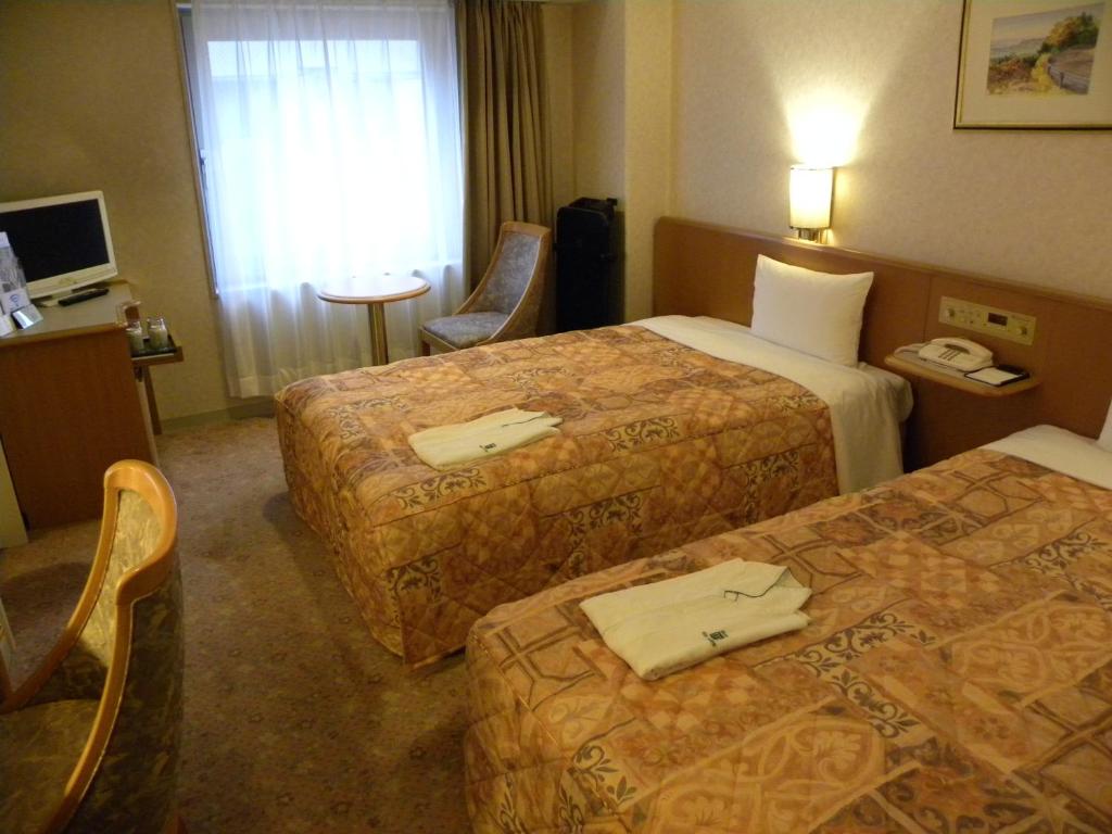 Ліжко або ліжка в номері Hotel New Green Okachimachi