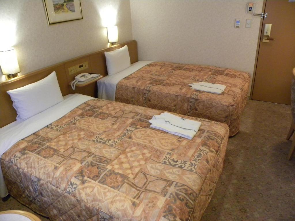 Postel nebo postele na pokoji v ubytování Hotel New Green Okachimachi