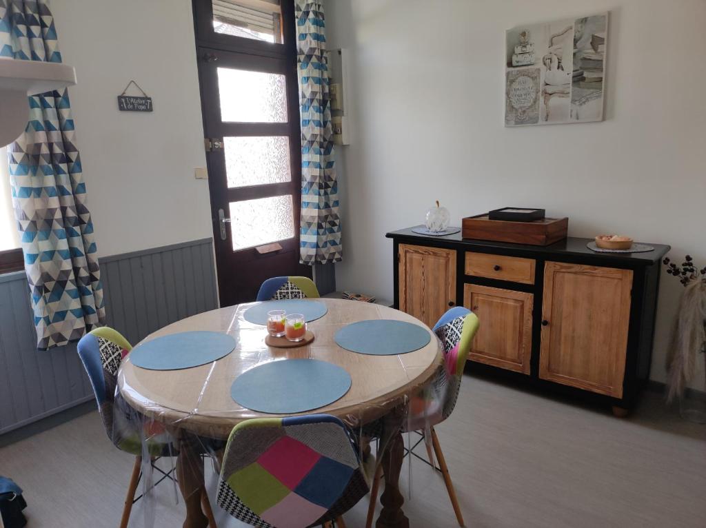 a table in a room with chairs around it at L Atelier de papa in Dargnies