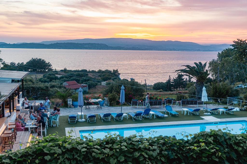 a resort with a pool and a view of the water at Metaxatos Apartments in Lassi
