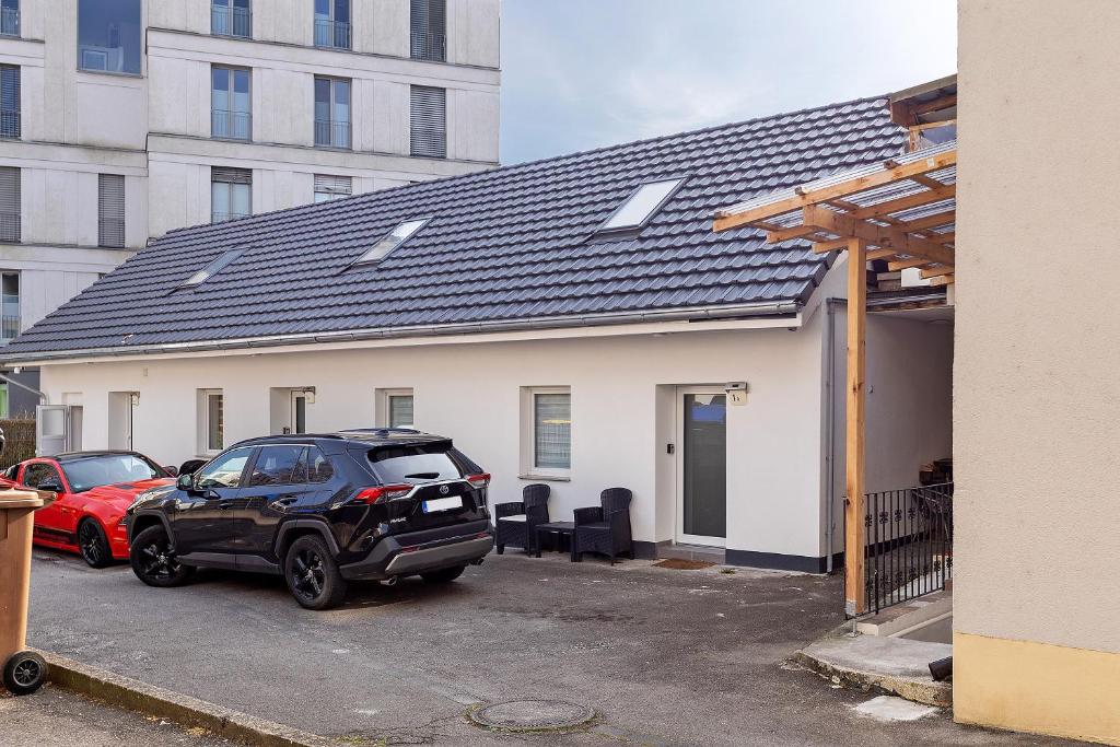 a car parked in a parking lot in front of a house at Fewo Mca in Rielasingen-Worblingen