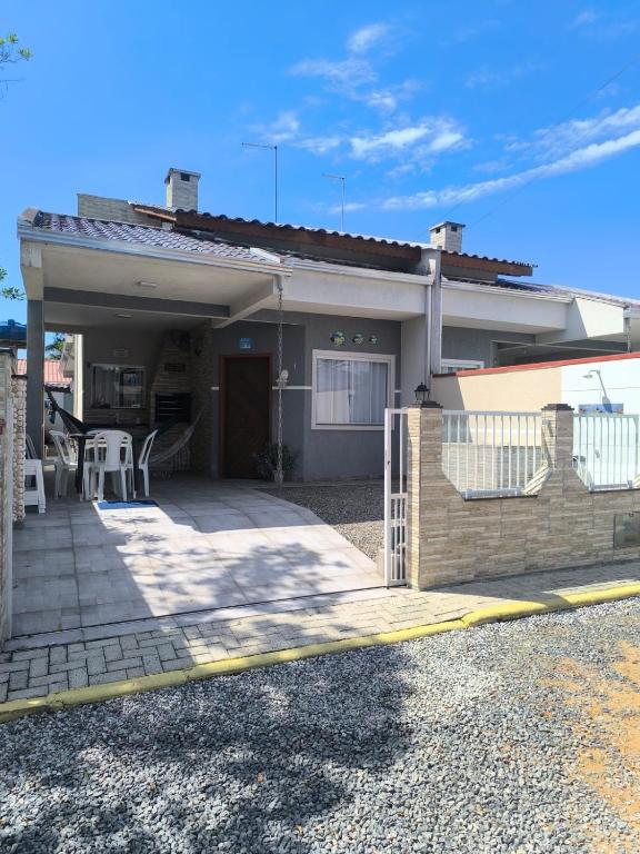 a house with a porch and a patio at Casa de Praia do Adriano in Itapoa