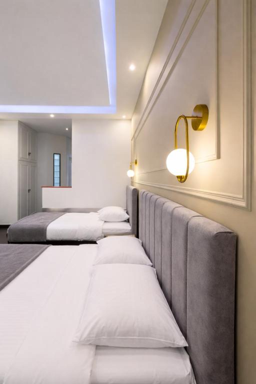 a row of beds in a room at NOHO Boutique Koukaki , premium living in Athens