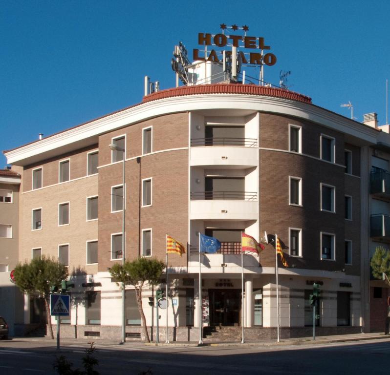 a hotel with a sign on top of a building at Hotel lázaro in Calamocha