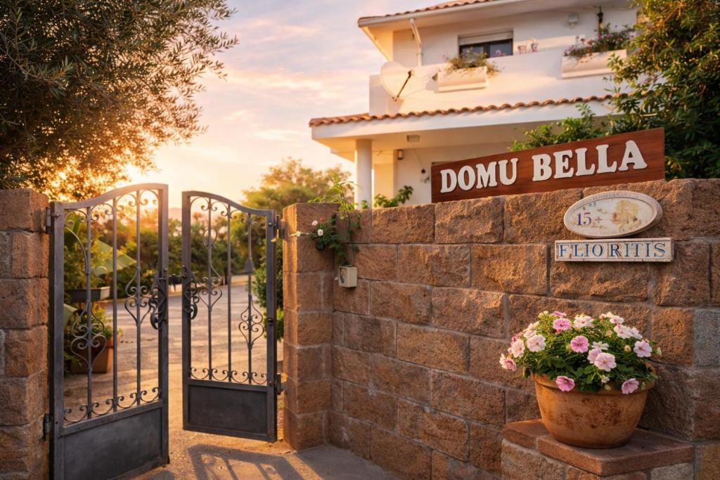 a gate to a house with a sign that reads donut belka at Domu Bella in Decimomannu