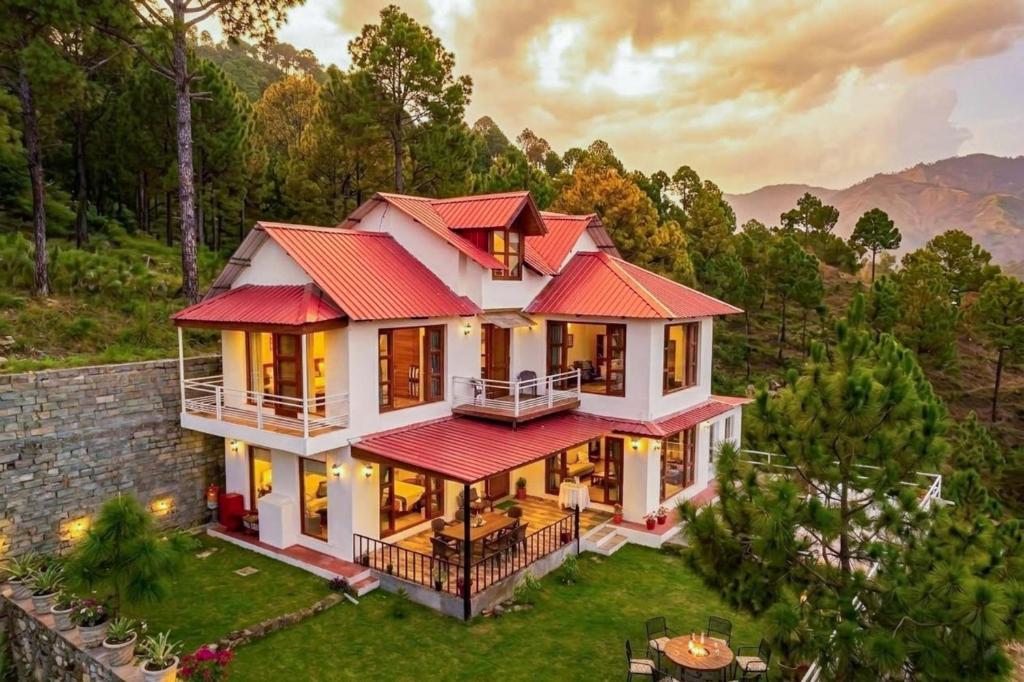 an aerial view of a house with a red roof at StayVista at The Haven 3BR Villa in Kasauli with Scenic Panoramic Views in Kasauli