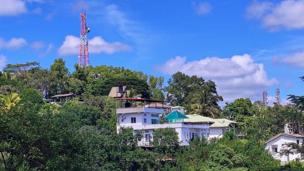 a house on top of a hill with a tower at Kandy Alpine Breeze in Kandy