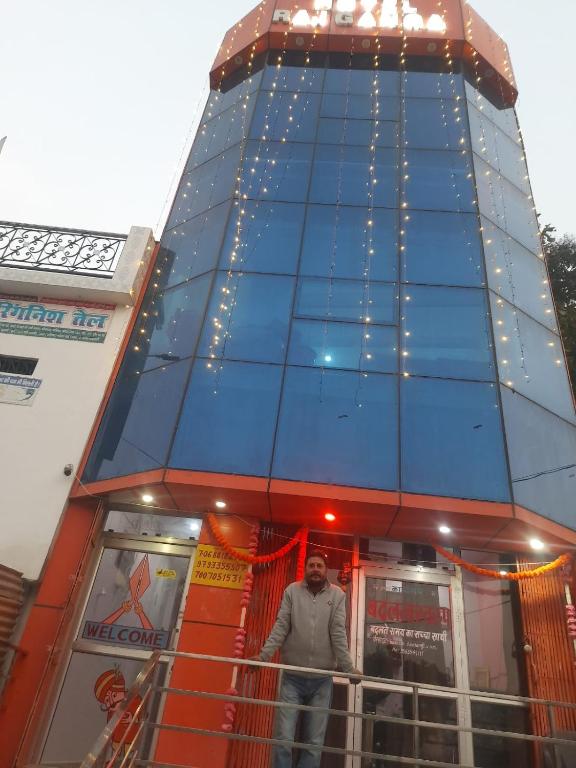 a man standing in front of a tall building at Hotel Rajganga in Gonda