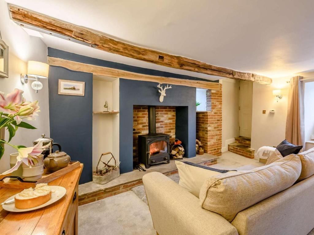 a living room with a couch and a fireplace at 2 Bed in York oc-91049 in Kirkbymoorside