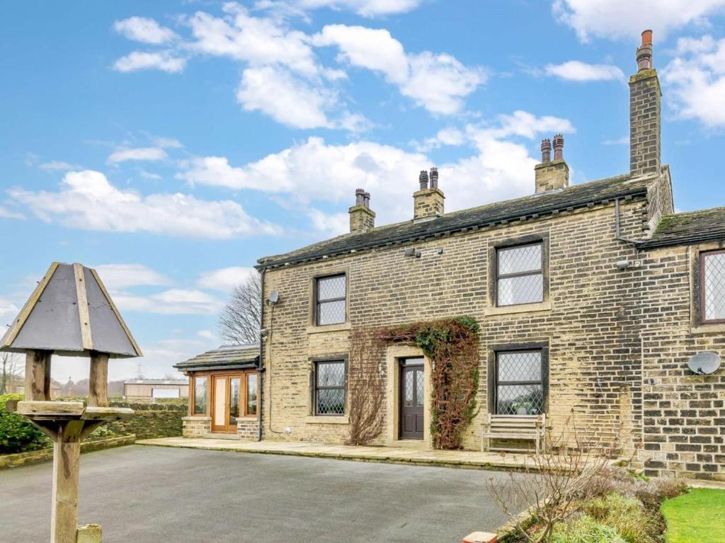 an old brick house with a sign in front of it at 3 Bed in Halifax oc-90209 in Sowerby Bridge