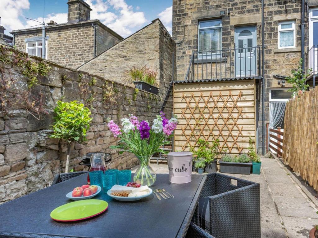 a black table with plates of food on a patio at 2 Bed in Harrogate oc-88933 in Pateley Bridge