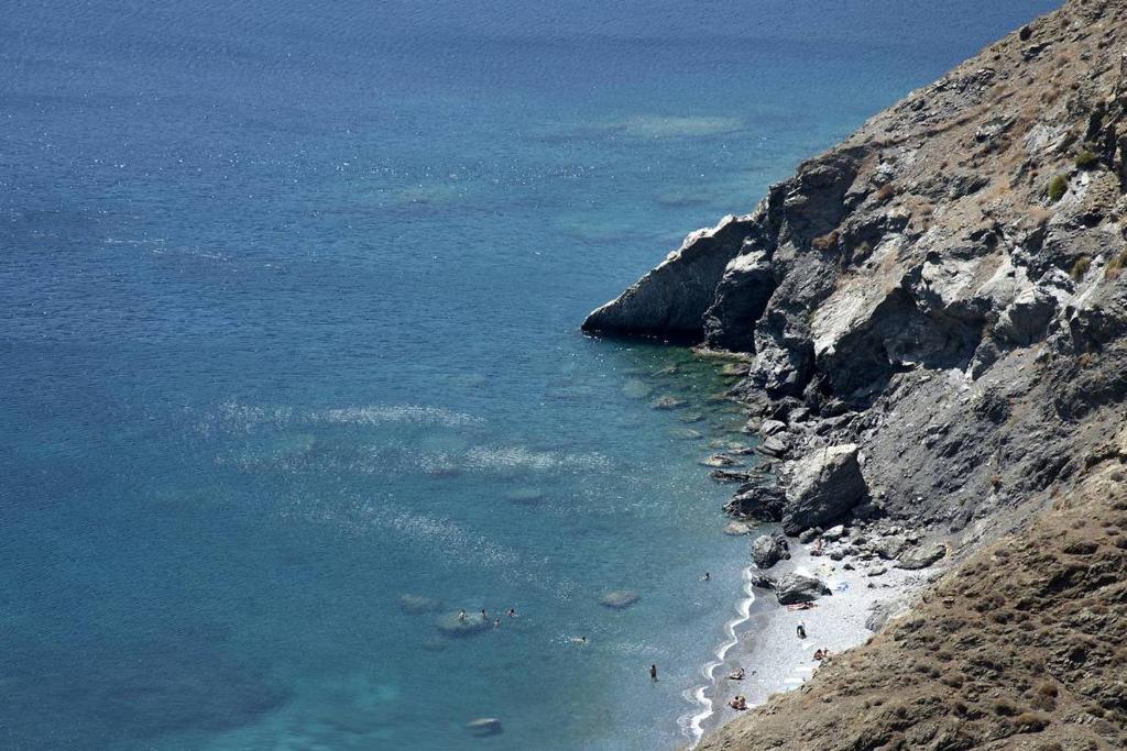a view of a beach next to a cliff at Asvestoti ciel fish house in Astypalaia