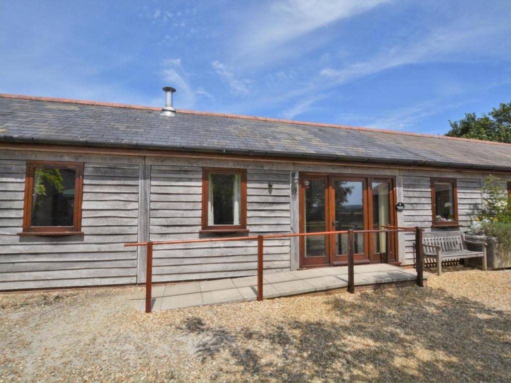 a large wooden house with a porch at 2 Bed in Sherborne oc-folwo in Long Burton