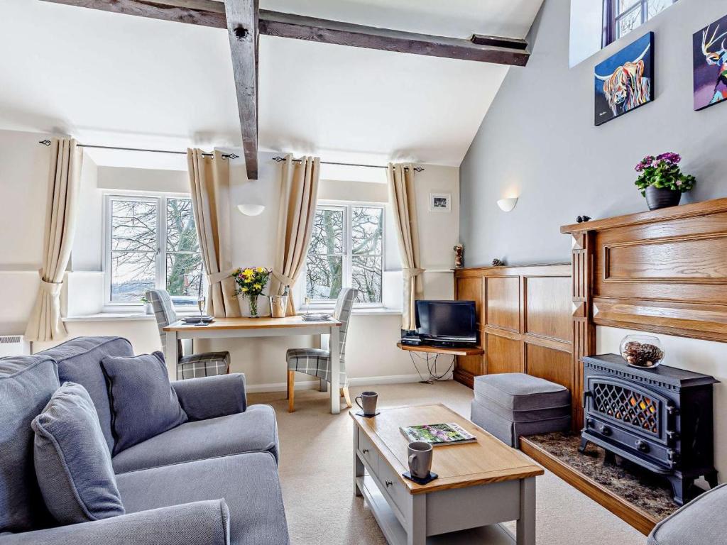a living room with a couch and a stove at 1 Bed in Dulverton oc-lbard in Dulverton