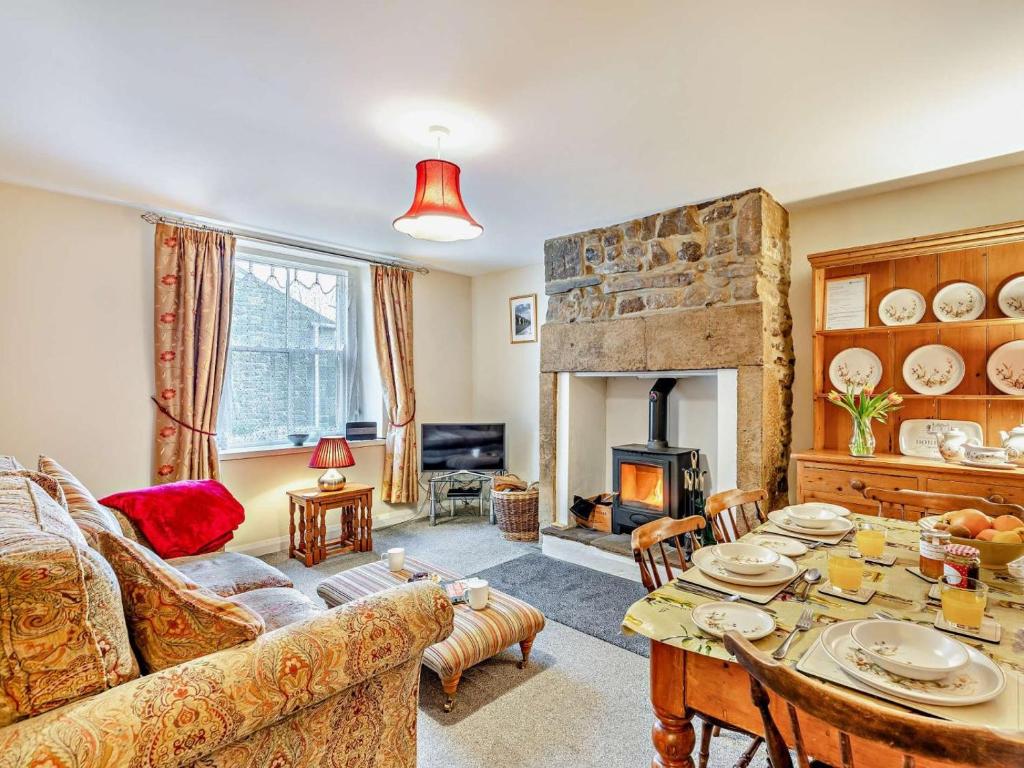 a living room with a table and a fireplace at 2 Bed in Hexham oc-50500 in Bellingham