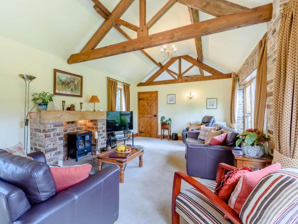 a living room with leather furniture and a fireplace at 3 Bed in York oc-83264 in High Catton