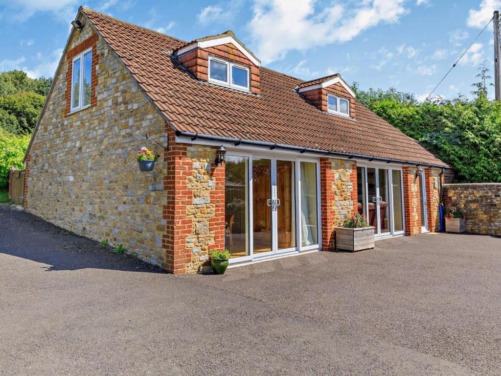 a red brick house with a large window at 3 Bed in Yeovil oc-htorv in Castle Cary
