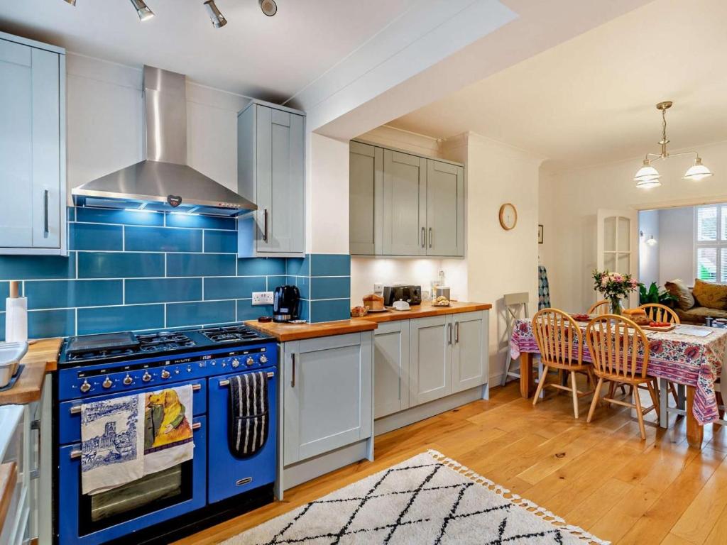 a kitchen with a stove and a dining room at 3 Bed in Ripon oc-94477 in Ripon
