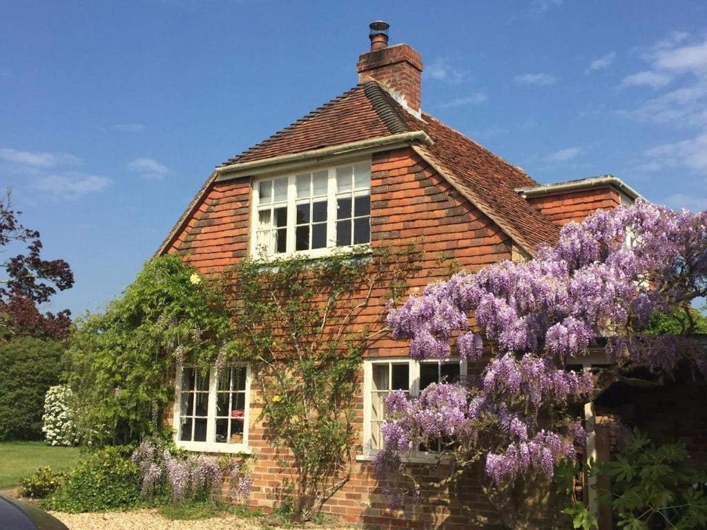 a house with a wreath of purple flowers on it at 1 Bed in Brockenhurst oc-78926 in Beaulieu